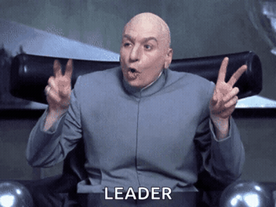 A Bald Man Sitting In A Chair With The Word Leader Written On The Bottom GIF