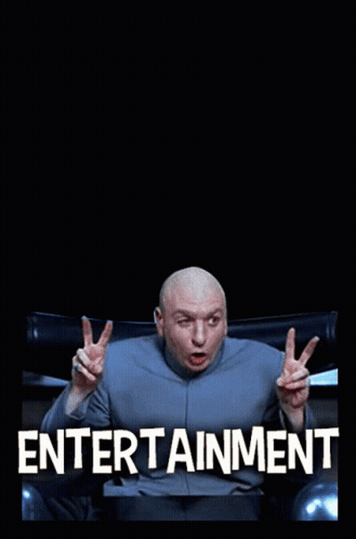 A Bald Man Sitting In Front Of The Hollywood Sign GIF