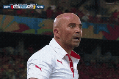 A Bald Man Stands In Front Of A Screen That Says Fifa World Cup Group B On It GIF