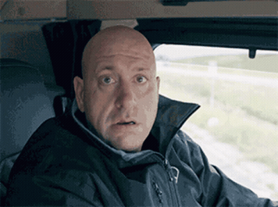 A Bald Man Wearing A Black Jacket Looks Surprised GIF