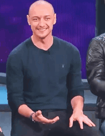 A Bald Man Wearing A Black Polo Shirt Is Clapping GIF