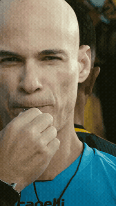 A Bald Man Wearing A Blue Shirt That Says Fadeli On It GIF