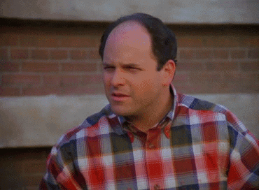 A Bald Man Wearing A Plaid Shirt Is Making A Face GIF