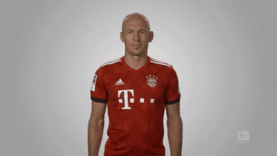 A Bald Man Wearing A Red Adidas Shirt With The Letter T On It GIF