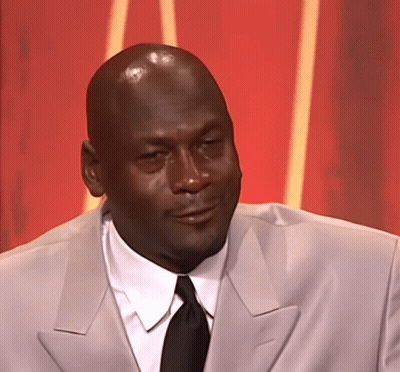 A Bald Man Wearing A Suit And Tie Looks To The Side GIF