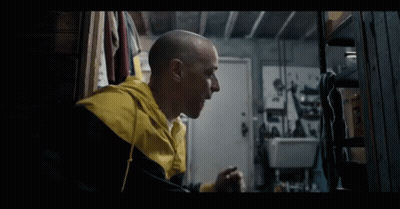 A Bald Man Wearing A Yellow And Black Jacket GIF