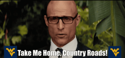 A Bald Man Wearing Glasses And A Suit Says Take Me Home Country Roads GIF