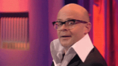 A Bald Man Wearing Glasses And A White Collar Is Making A Funny Face . GIF