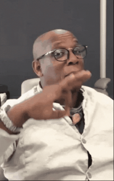 A Bald Man Wearing Glasses And A White Shirt GIF