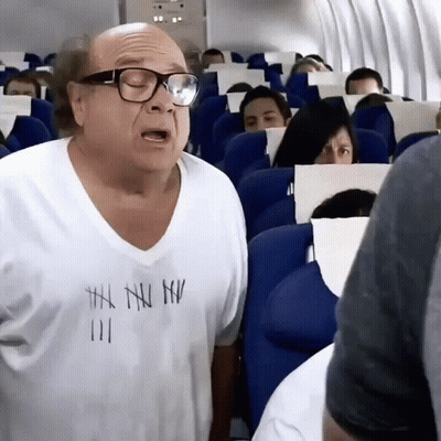 A Bald Man Wearing Glasses And A White Shirt That Says ' I 'M A Nu ' On It GIF