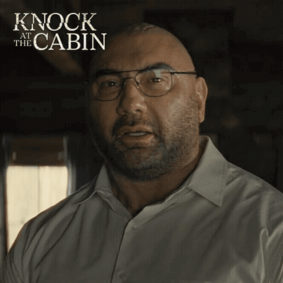 A Bald Man Wearing Glasses And A White Shirt With The Words Knock At The Cabin On The Bottom GIF