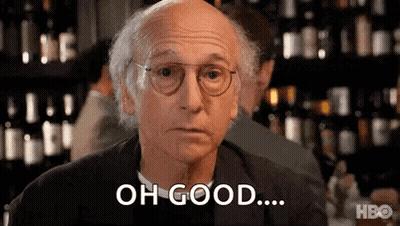 A Bald Man Wearing Glasses Is Sitting At A Table In Front Of A Bar And Saying `` Oh Good ... '' . GIF