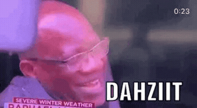 A Bald Man Wearing Glasses Is Smiling And Talking On A Radio Show . GIF