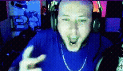 A Bald Man Wearing Headphones And A Blue Shirt Is Making A Peace Sign GIF