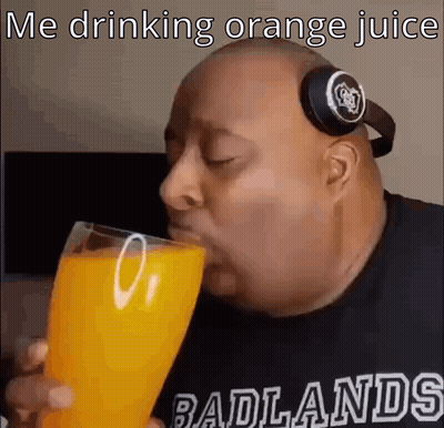 A Bald Man Wearing Headphones Is Drinking Orange Juice . GIF