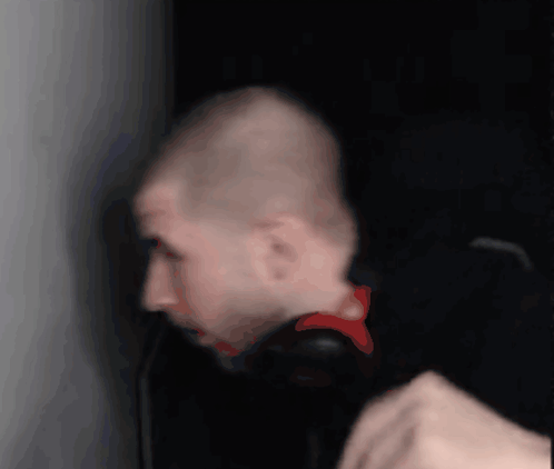 A Bald Man Wearing Headphones Looks At Something GIF