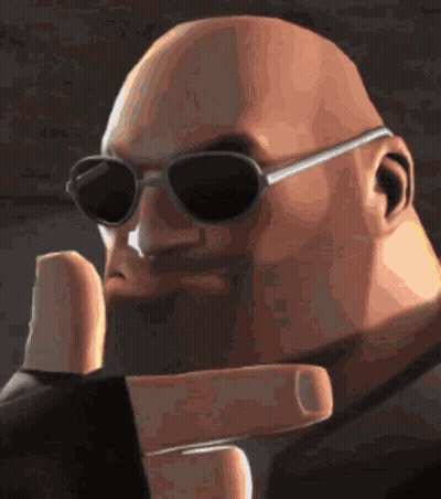 A Bald Man Wearing Sunglasses And A Black Jacket Is Making A Peace Sign . GIF