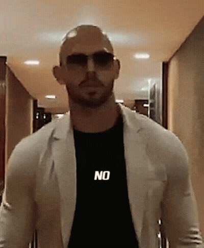 A Bald Man Wearing Sunglasses And A Black Shirt That Says No GIF
