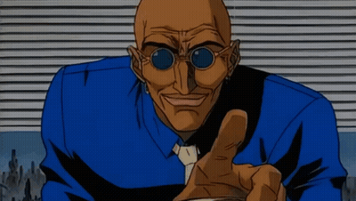 A Bald Man Wearing Sunglasses And A Blue Shirt Is Pointing His Finger GIF