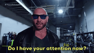 A Bald Man Wearing Sunglasses And A Leather Jacket Says " Do I Have Your Attention Now " GIF