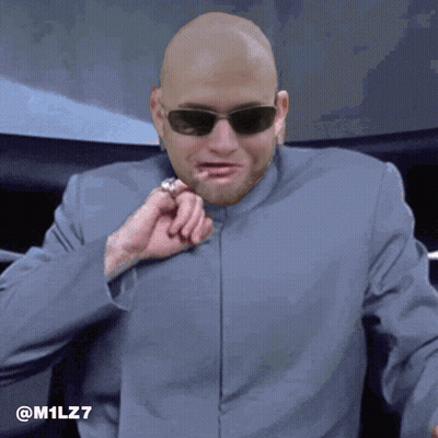 A Bald Man Wearing Sunglasses And A Suit Has The Hashtag M1lz7 On The Bottom GIF