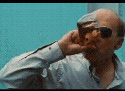 A Bald Man Wearing Sunglasses Is Drinking From A Glass Of Beer . GIF