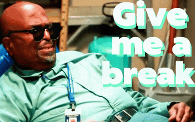 A Bald Man Wearing Sunglasses Sits In A Chair And Says Give Me A Break GIF