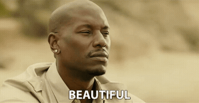 A Bald Man With A Beard And Earrings Says Beautiful GIF