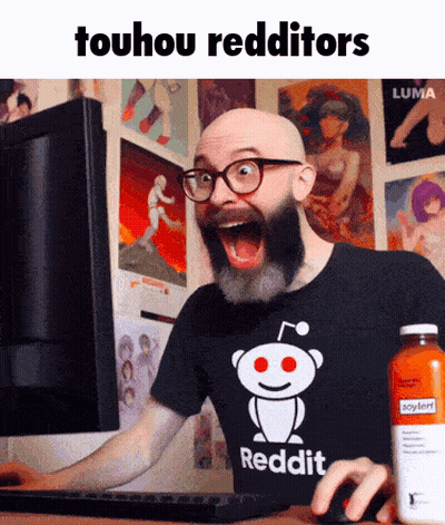 A Bald Man With A Beard And Glasses Is Using A Computer While Wearing A Reddit Shirt GIF