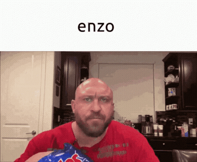 A Bald Man With A Beard Is Holding A Bag Of M & Ms GIF