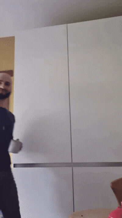 A Bald Man With A Beard Is Holding A Cup GIF