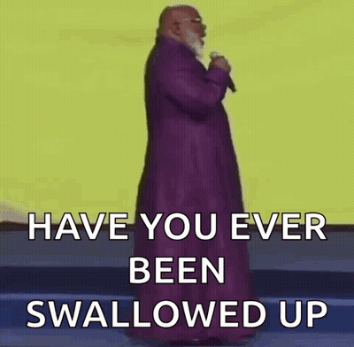 A Bald Man With A Beard Is Holding A Microphone And Says `` Have You Ever Been Swallowed Up '' . GIF
