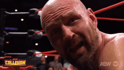 A Bald Man With A Beard Is In A Wrestling Ring With The Aew Collision Logo Behind Him GIF