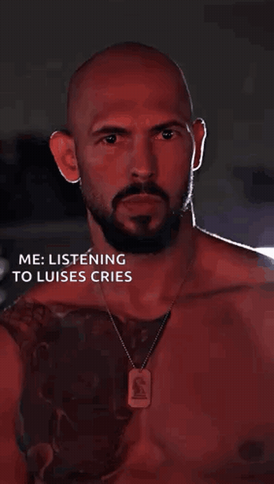A Bald Man With A Beard Is Listening To Luises Cries While Wearing A Dog Tag Necklace . GIF