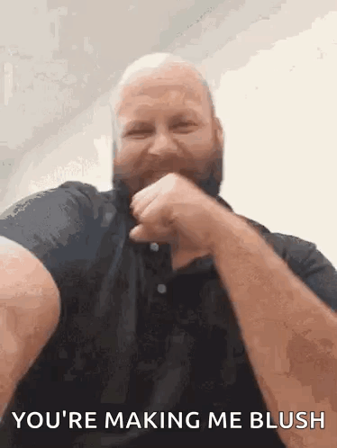 A Bald Man With A Beard Is Making A Funny Face And Says `` You 'Re Making Me Blush '' . GIF