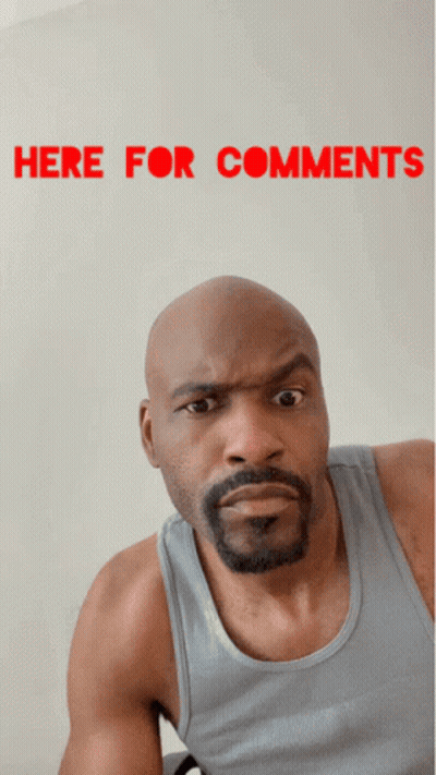 A Bald Man With A Beard Is Making A Funny Face In Front Of A Sign That Says " Here For Comments " GIF