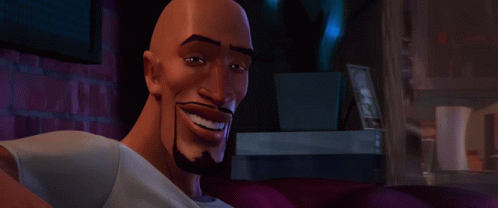 A Bald Man With A Beard Is Smiling And Looking At The Camera GIF