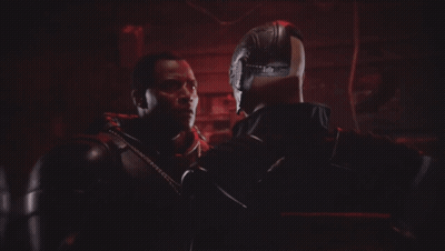 A Bald Man With A Beard Is Smiling In Front Of Another Bald Man GIF