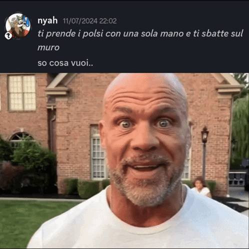 A Bald Man With A Beard Is Standing In Front Of A House GIF