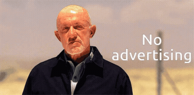 A Bald Man With A Beard Is Standing In Front Of A Sign That Says No Advertising GIF
