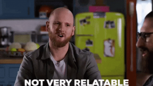 Bald Man With Beard Talking To Another In Kitchen GIF