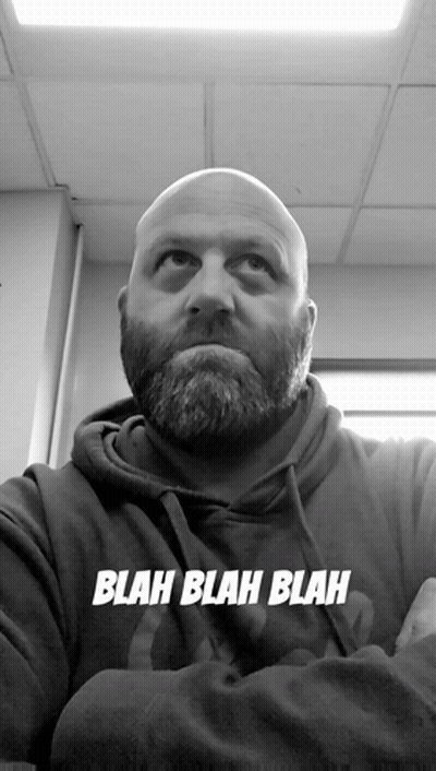 A Bald Man With A Beard Is Wearing A Blah Blah Blah Hoodie GIF