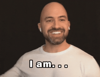 A Bald Man With A Beard Is Wearing A White Shirt That Says " I Am " On It GIF