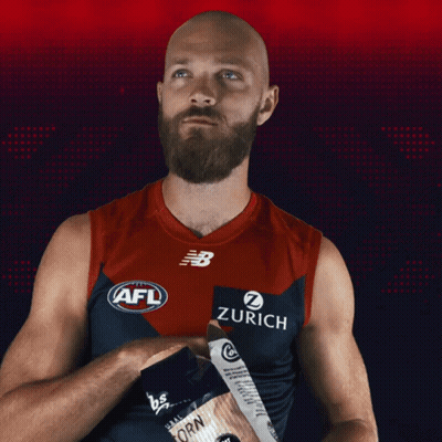 A Bald Man With A Beard Is Wearing An Afl Jersey With Zurich On It GIF