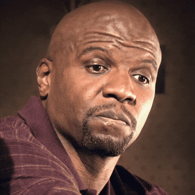A Bald Man With A Beard Looks At The Camera With A Serious Look On His Face GIF