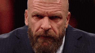 A Bald Man With A Beard Wearing A Blue Suit GIF