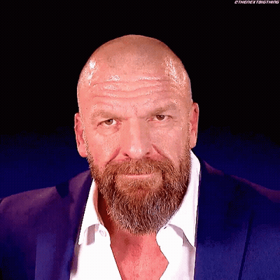 A Bald Man With A Beard Wearing A Blue Suit GIF