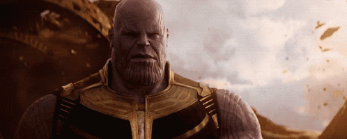 A Bald Man With A Beard Wearing A Gold And Black Suit GIF