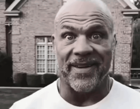 A Bald Man With A Beard Wearing A White Shirt GIF