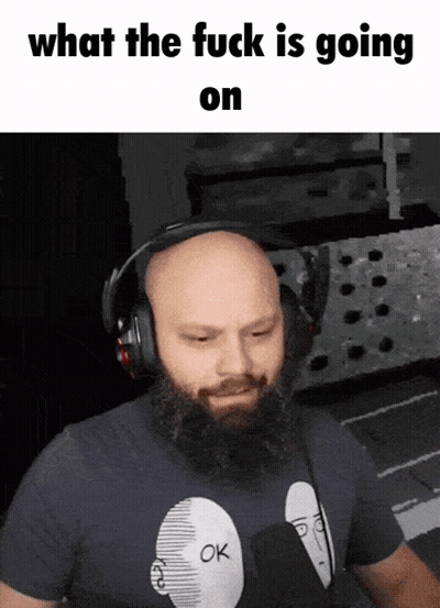 A Bald Man With A Beard Wearing Headphones And A Shirt That Says Ok On It GIF